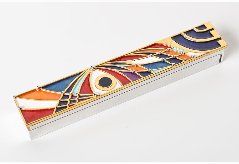 An Art Deco mezuzah, inlaid with enamel in striking colors.